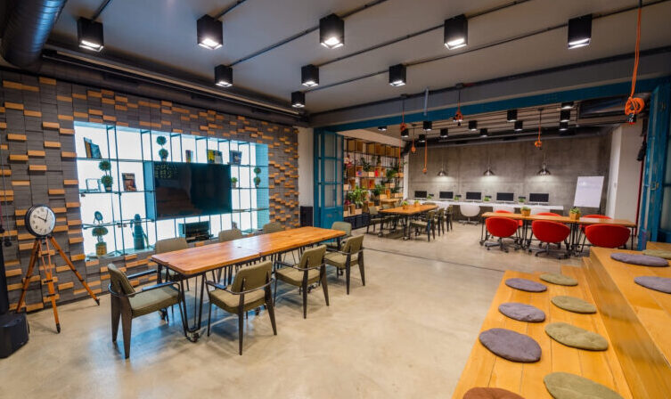 Interior architect designing a modern open-concept living space with floor plans and materials.